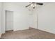 Bright bedroom with neutral carpet, white walls, closet, and adjacent doorway for convenient access at 4718 E Decatur St, Mesa, AZ 85205