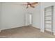 Bedroom with open door and closet with shelving at 4718 E Decatur St, Mesa, AZ 85205