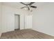 Bedroom featuring neutral carpet, bright white walls, a modern ceiling fan, and a closet for ample storage at 4718 E Decatur St, Mesa, AZ 85205