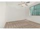 A well lit bedroom featuring neutral carpet, ceiling fan, and a window that provides great natural light at 4718 E Decatur St, Mesa, AZ 85205