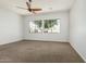 Spacious bedroom with modern ceiling fan and large windows at 4718 E Decatur St, Mesa, AZ 85205