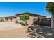 Single-story home featuring desert landscaping, a gated side entrance, and a well-maintained exterior at 4718 E Decatur St, Mesa, AZ 85205