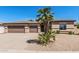 Charming single-story home featuring a well-manicured front yard with desert landscaping and a three-car garage at 4718 E Decatur St, Mesa, AZ 85205