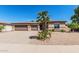 Charming single-story home featuring a well-manicured front yard with desert landscaping and a three-car garage at 4718 E Decatur St, Mesa, AZ 85205