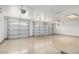 Large two car garage featuring painted walls and floors with dual garage doors and modern door openers at 4718 E Decatur St, Mesa, AZ 85205