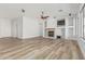 Open-concept living room featuring wood flooring, fireplace, and large windows for ample natural light at 4718 E Decatur St, Mesa, AZ 85205