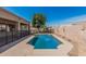 A refreshing swimming pool surrounded by desert landscaping and a secure safety fence at 4718 E Decatur St, Mesa, AZ 85205