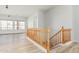 Hallway with a light-toned wood floor and stairs with a wooden railing for a classic look at 4718 E Decatur St, Mesa, AZ 85205