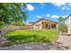 Large backyard featuring lush green grass, mature trees, and a privacy fence at 4811 W Oakland St, Chandler, AZ 85226