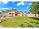 Expansive backyard features a well-maintained lawn, mature landscaping, and a covered patio, great for entertaining at 4811 W Oakland St, Chandler, AZ 85226