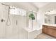 Bright bathroom with a glass-enclosed shower and a separate soaking tub at 4811 W Oakland St, Chandler, AZ 85226