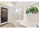 Modern bathroom featuring a glass shower, separate tub, and natural light at 4811 W Oakland St, Chandler, AZ 85226