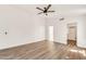 Spacious bedroom boasts wood-look floors, a ceiling fan, neutral walls and an en-suite bathroom with walk-in closet at 4811 W Oakland St, Chandler, AZ 85226