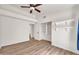 Cozy bedroom boasts wood-look floors, a ceiling fan, neutral walls and an en-suite bathroom with walk-in closet at 4811 W Oakland St, Chandler, AZ 85226