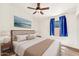Comfortable bedroom featuring soft carpeting, a ceiling fan, a large picture window, and an artistic wall decoration at 4811 W Oakland St, Chandler, AZ 85226