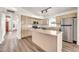 Modern kitchen with stainless steel appliances, a center island, and hardwood floors at 4811 W Oakland St, Chandler, AZ 85226