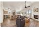 Bright living room with a fireplace, hardwood floors, and an open view of the kitchen at 4811 W Oakland St, Chandler, AZ 85226