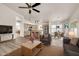 Open-concept living room featuring hardwood floors, a ceiling fan, and ample natural light at 4811 W Oakland St, Chandler, AZ 85226