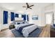 Comfortable main bedroom featuring hardwood floors, a ceiling fan, and large windows at 4811 W Oakland St, Chandler, AZ 85226