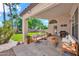 Inviting covered patio with comfortable seating, a grill, and views of the backyard at 4811 W Oakland St, Chandler, AZ 85226
