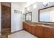 Well-lit bathroom with dual vanities, granite countertops, and a walk-in shower at 5208 S Gold Leaf Pl, Chandler, AZ 85249