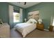 Serene bedroom with green walls, a comfortable bed, and ample natural light at 5208 S Gold Leaf Pl, Chandler, AZ 85249