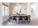 Well-lit dining room features modern lighting fixture, ample windows, and neutral décor at 5208 S Gold Leaf Pl, Chandler, AZ 85249