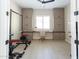 This home gym features a weight rack, tile flooring, and large cabinets for all storage needs at 5208 S Gold Leaf Pl, Chandler, AZ 85249