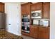 Modern kitchen featuring stainless steel double ovens, microwave and granite countertops with ample cabinet space at 5208 S Gold Leaf Pl, Chandler, AZ 85249