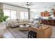 Spacious living room featuring large windows and an oversized sectional sofa, perfect for entertaining guests at 5208 S Gold Leaf Pl, Chandler, AZ 85249