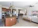 Open-concept layout connects the kitchen to the living room featuring neutral furniture and bright natural light at 5208 S Gold Leaf Pl, Chandler, AZ 85249