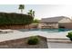Backyard pool featuring decorative stone with lush greenery and desert landscaping at 5208 S Gold Leaf Pl, Chandler, AZ 85249