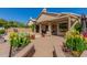 Beautiful backyard with a covered patio, pool, lush landscaping and flowers at 5215 W Del Rio St, Chandler, AZ 85226