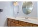 Bright bathroom with dual sinks, updated fixtures and two round mirrors at 5215 W Del Rio St, Chandler, AZ 85226
