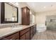 Spacious primary bathroom with double sinks, soaking tub, and glass shower at 5215 W Del Rio St, Chandler, AZ 85226