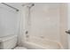 Bright bathroom featuring a shower-tub combo with white tile surround and updated fixtures at 5215 W Del Rio St, Chandler, AZ 85226