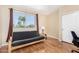 Cozy room featuring wood look floors, large window and convertible futon at 5215 W Del Rio St, Chandler, AZ 85226