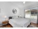 Comfortable bedroom showcasing hardwood floors, a ceiling fan and a large window at 5215 W Del Rio St, Chandler, AZ 85226