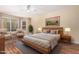 Comfortable primary bedroom with a ceiling fan, hardwood floors and ample natural light at 5215 W Del Rio St, Chandler, AZ 85226