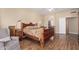 Cozy bedroom featuring wood frame bed, sitting chair, and ample natural light at 5215 W Del Rio St, Chandler, AZ 85226