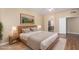 Bedroom with hardwood floors, neutral color scheme and ensuite bathroom at 5215 W Del Rio St, Chandler, AZ 85226