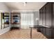 Bright bonus room featuring Murphy bed, hardwood floors, storage shelf and a large mirror at 5215 W Del Rio St, Chandler, AZ 85226