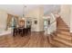 Charming dining area with a large table, wood floors, and staircase access to the upper level of the home at 5215 W Del Rio St, Chandler, AZ 85226