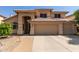 Charming two-story home featuring a tile roof, arched entryway, and a spacious three car garage at 5215 W Del Rio St, Chandler, AZ 85226