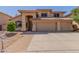 Charming two-story home with a three-car garage, arched entryway, and well-manicured landscaping at 5215 W Del Rio St, Chandler, AZ 85226