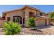 Beautiful exterior featuring a well-kept yard and a spacious three-car garage, complemented by desert landscaping at 5215 W Del Rio St, Chandler, AZ 85226