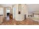 Bright hallway showcasing wood floors, open staircase, and architectural details at 5215 W Del Rio St, Chandler, AZ 85226
