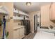 Well-organized laundry room equipped with storage cabinets, utility sink, and modern appliances at 5215 W Del Rio St, Chandler, AZ 85226