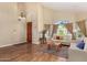 Cozy living room area with high ceilings, large arched window, and comfortable seating arrangement with natural light at 5215 W Del Rio St, Chandler, AZ 85226
