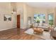 Inviting living room with hardwood floors, large windows, plush seating and natural light at 5215 W Del Rio St, Chandler, AZ 85226